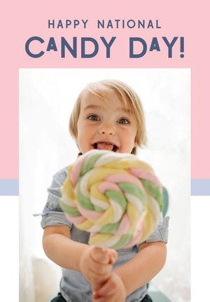 Child holding a big swirl lollipop